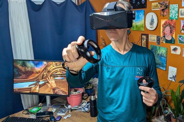 Alan Truly is enjoying a VR game with the Pimax Crystal Light.