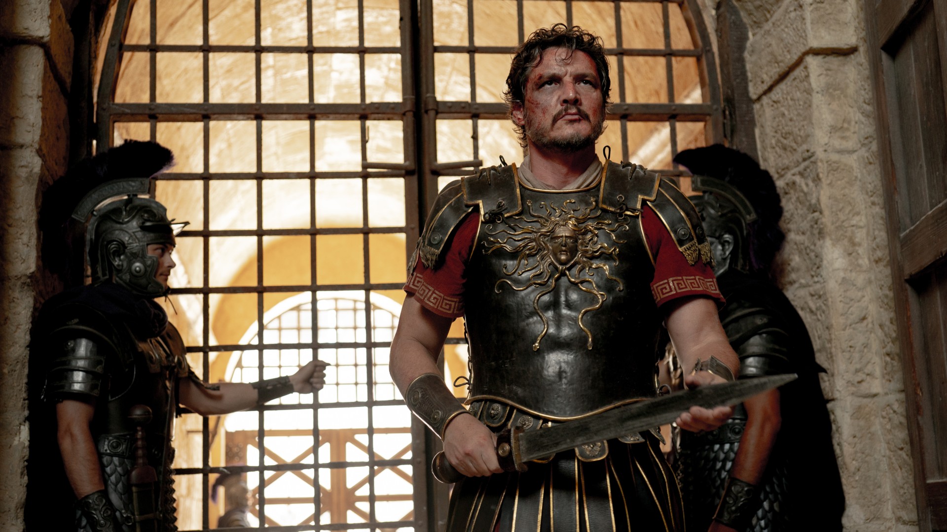 Pedro Pascal cradles a sword in a shot from the movie Gladiator II.