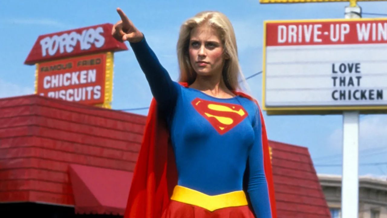 Helen Slater as Supergirl pointing to the distance.