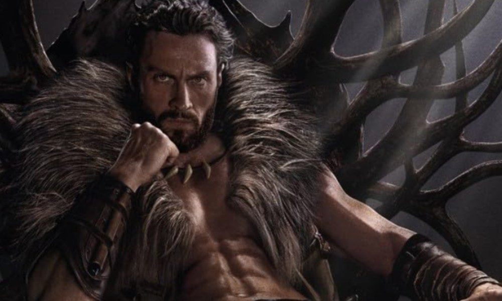 Aaron Taylor-Johnson as Kraven the Hunter sitting on a throne and looking at the camera.