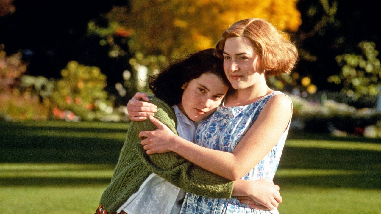 Melanie Lynskey and Kate Winslet as Pauline and Juliet embracing while walking in Heavenly Creatures.