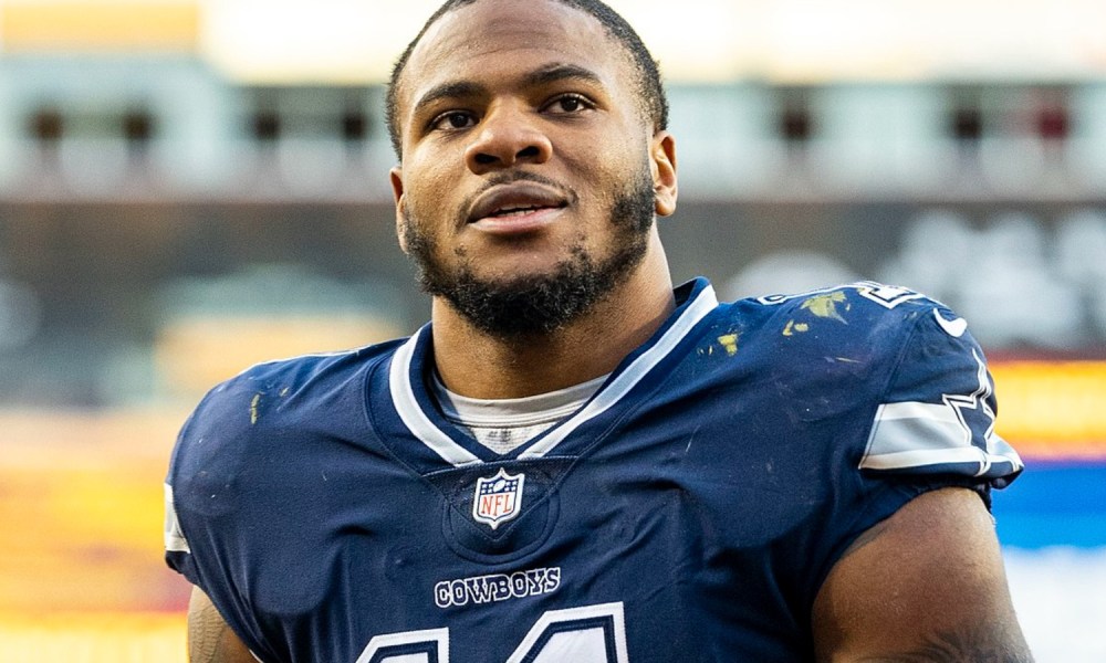 Micah Parsons of the Dallas Cowboys walks off the field and looks up.