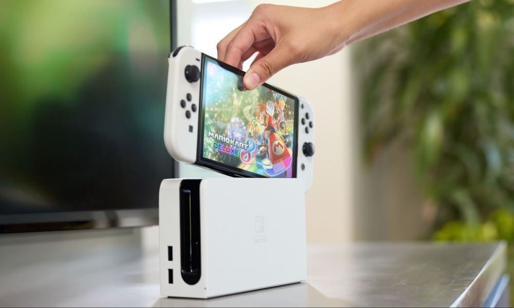 Someone picks up a Nintendo Switch OLED Model.