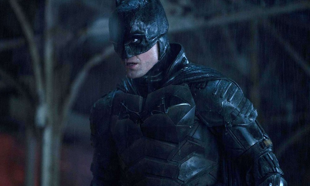 Robert Pattinson wears the Batsuit in the rain in The Batman.