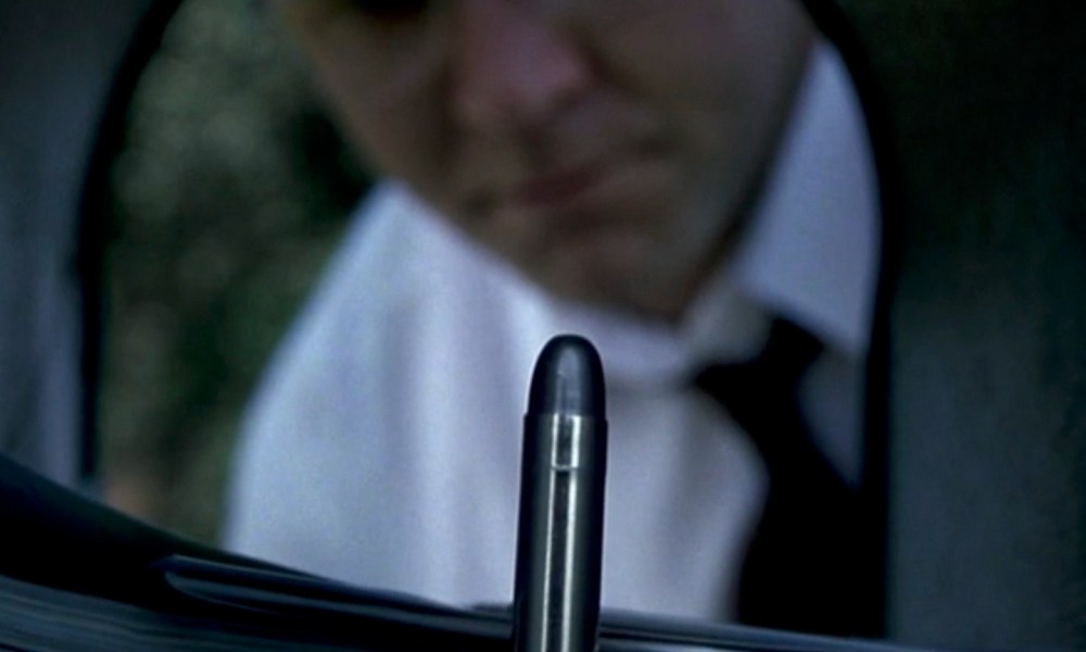 Russell Crowe looks at a bullet inside a mailbox in The Insider.