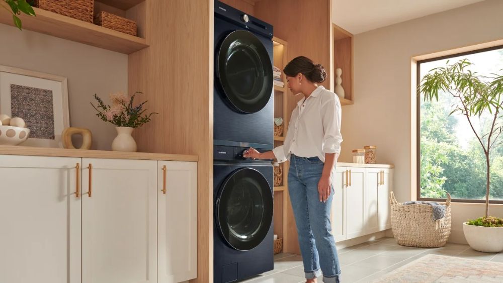 A person using the Samsung Smart Washer and Dryer.