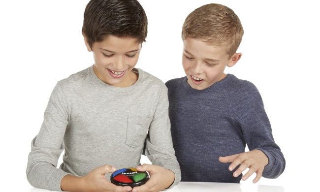 Two boys playing with a Simon Says Micro.