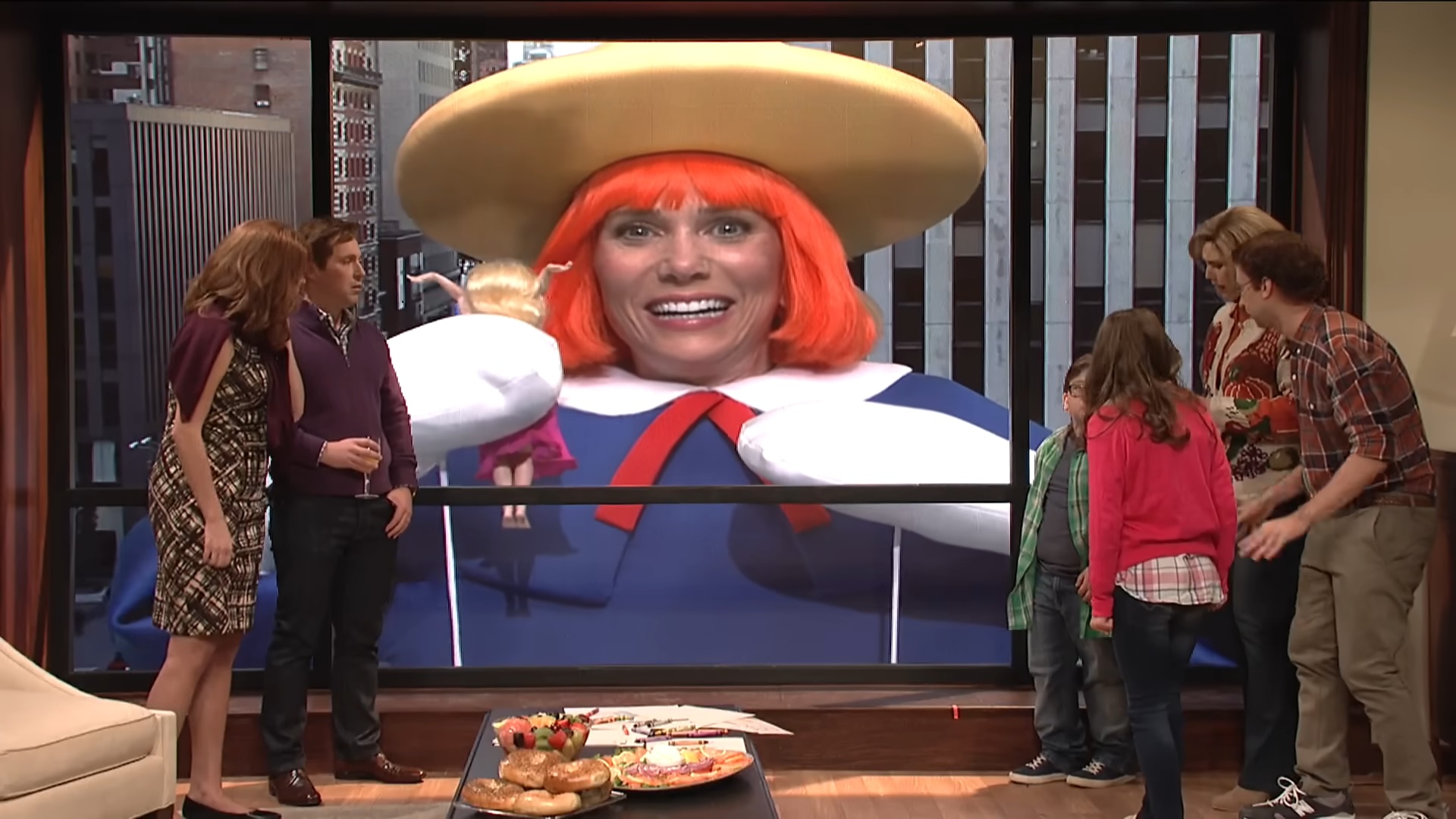 A family watching a parade float holding a woman in "Saturday Night Live."