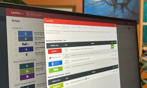 The LastPass web app is open on a PC monitor.