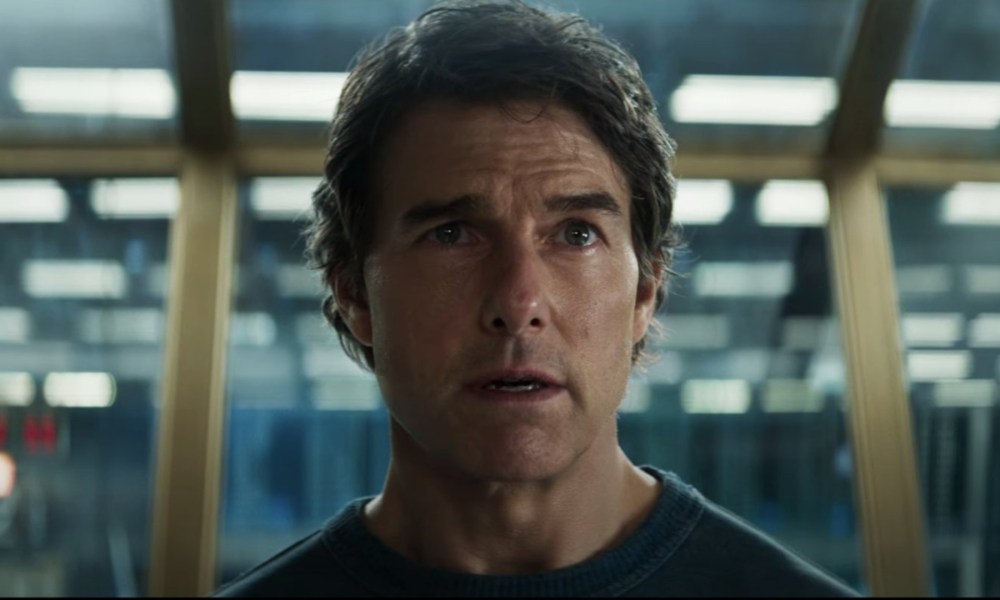 Tom Cruise stares with a concerned look on his face.