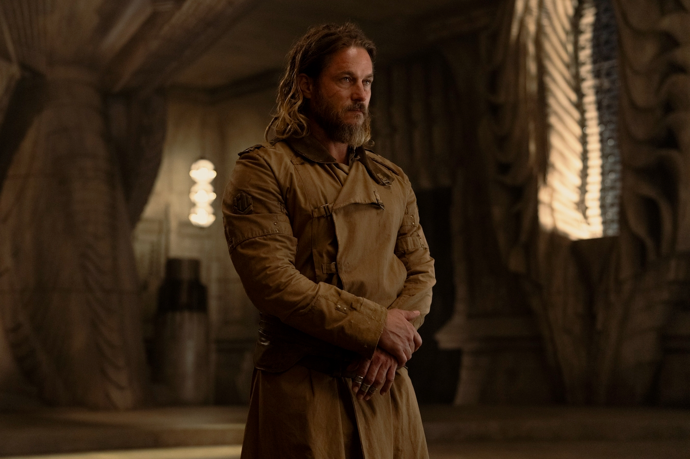 Travis Fimmel stands in a royal palace in Dune: Prophecy.