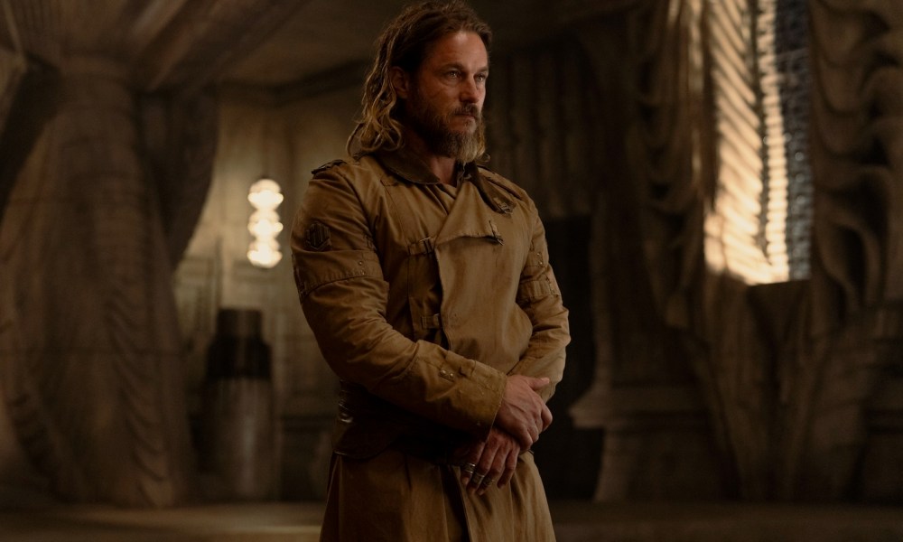 Travis Fimmel stands in a royal palace in Dune: Prophecy.