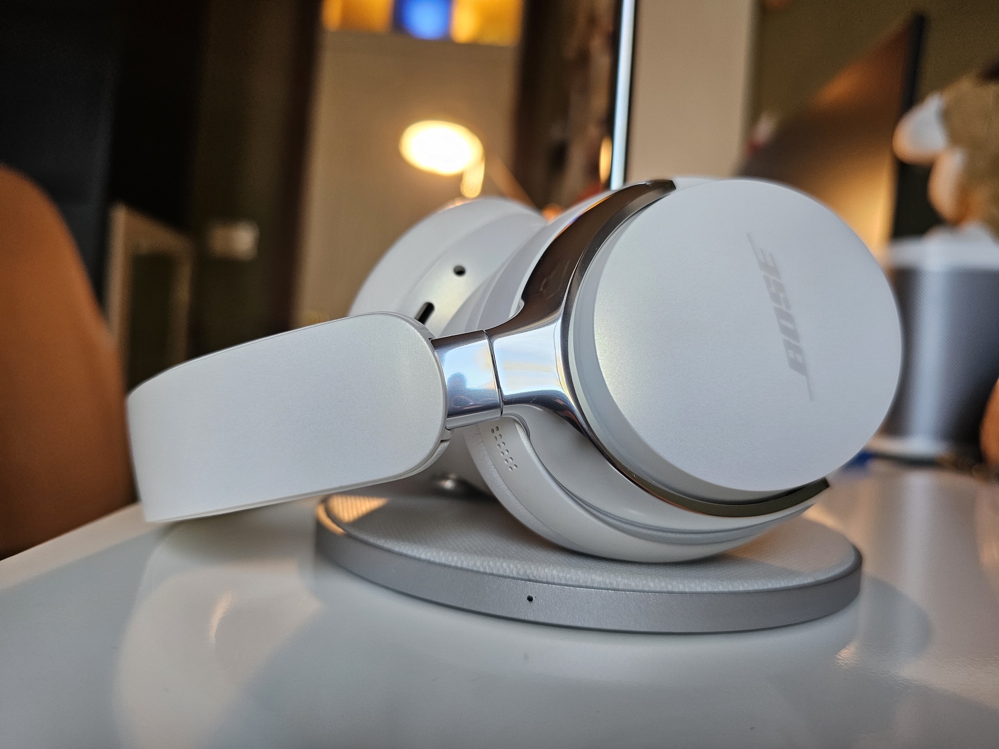 The Bose QuietComfort Ultra Headphones in the Diamond 60th Anniversary color resting on a table.