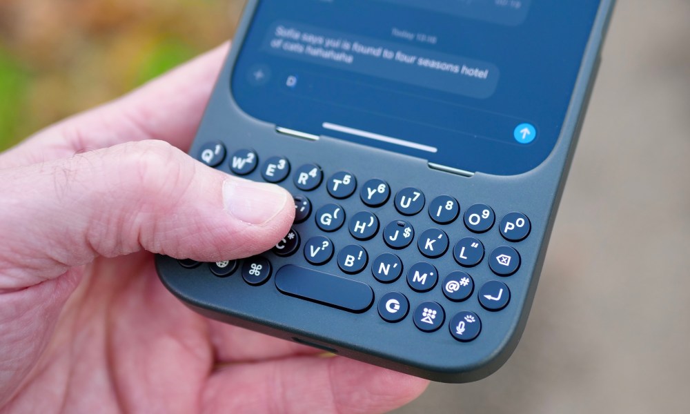 A person holding the Clicks Keyboard case.