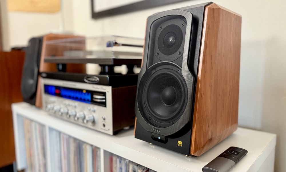 The Edifier S1000W bookshelf speakers on a shelf with a Marantz receiver and a record player.