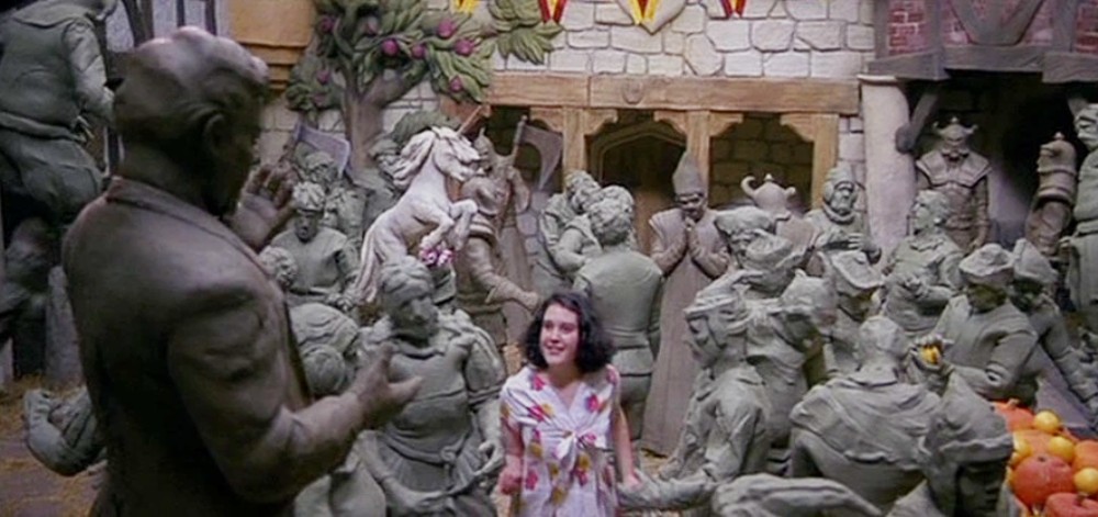 A young girl looks at fantastical statues in Heavenly Creatures.