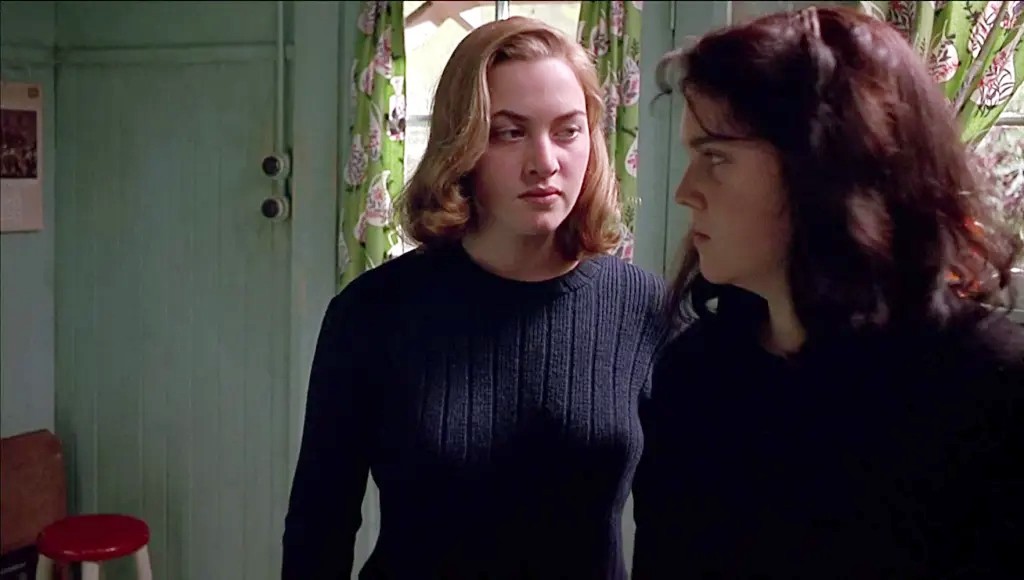 Two girls look at each other in Heavenly Creatures.