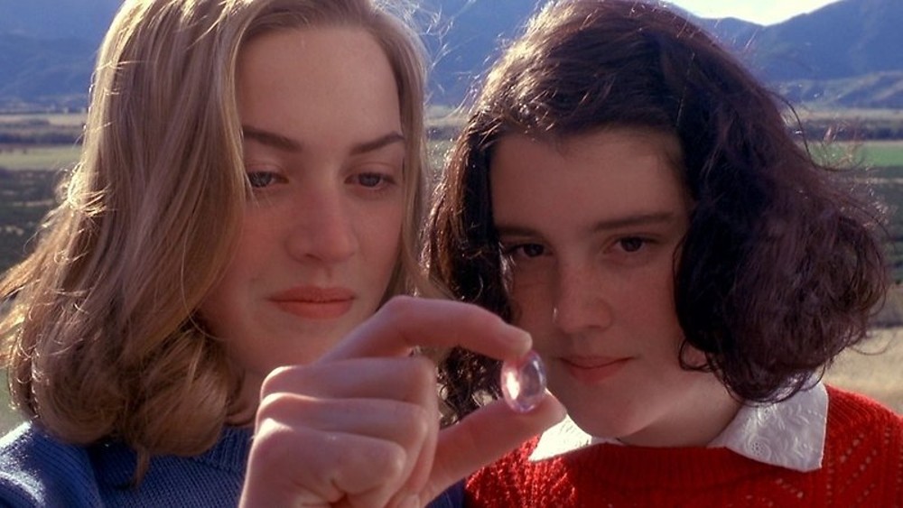 Two girls look at a jewel in Heavenly Creatures.