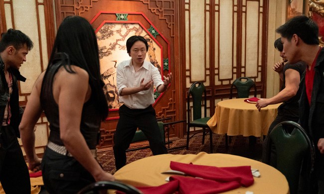 A man gets ready to fight others in a restaurant using martial arts in Interior Chinatown.