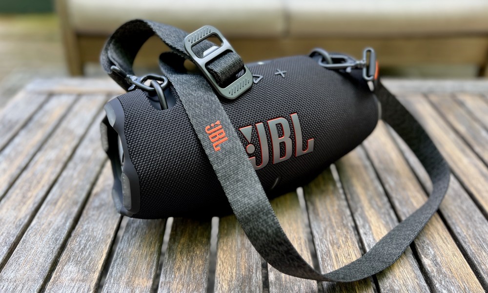 The JBL Xtreme 4 Bluetooth speaker on an ooutdoor table.