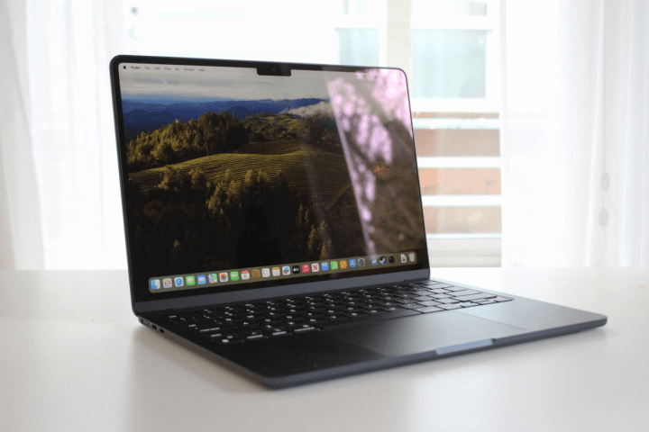 The MacBook Air on a table in front of a window.