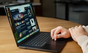 Someone using a MacBook Pro at a desk.