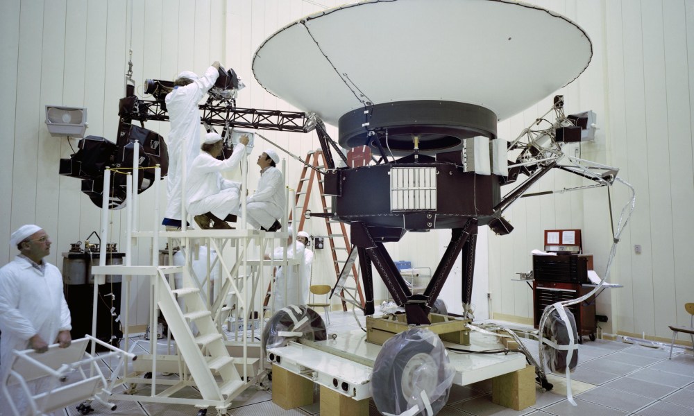 This archival photo shows engineers working on NASA's Voyager 2 spacecraft on March 23, 1977.