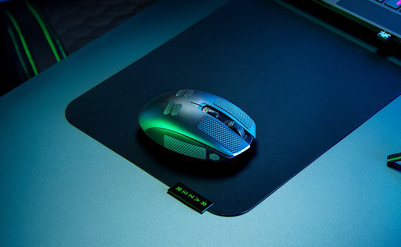 The Razer Orochi V2 on a mousepad on a desk.