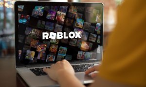 A laptop with a Roblox wallpaper.