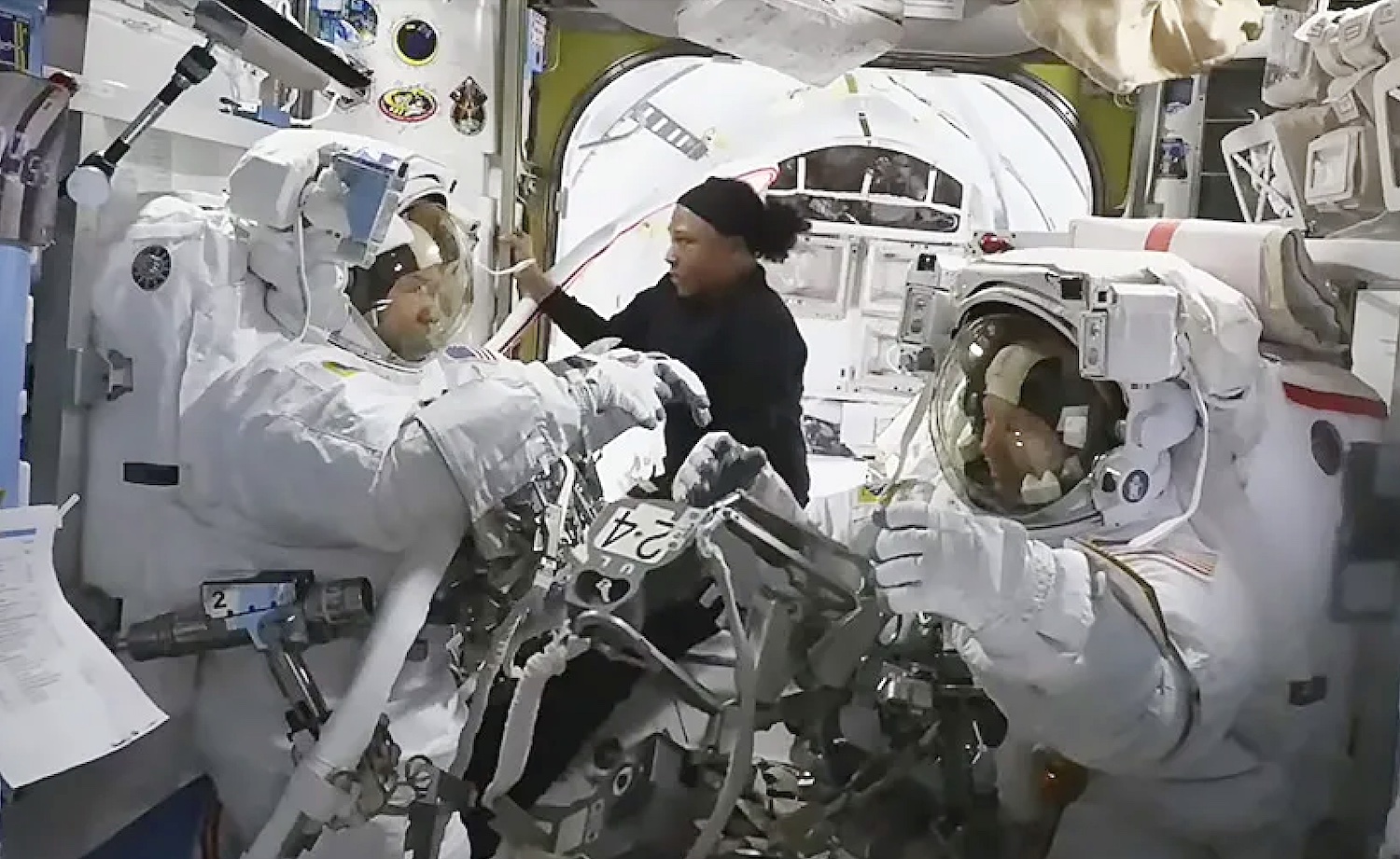 NASA astronaut Jeanette Epps (center) assists NASA astronauts Mike Barratt (left) and Tracy C. Dyson wrong nan Quest airlock.