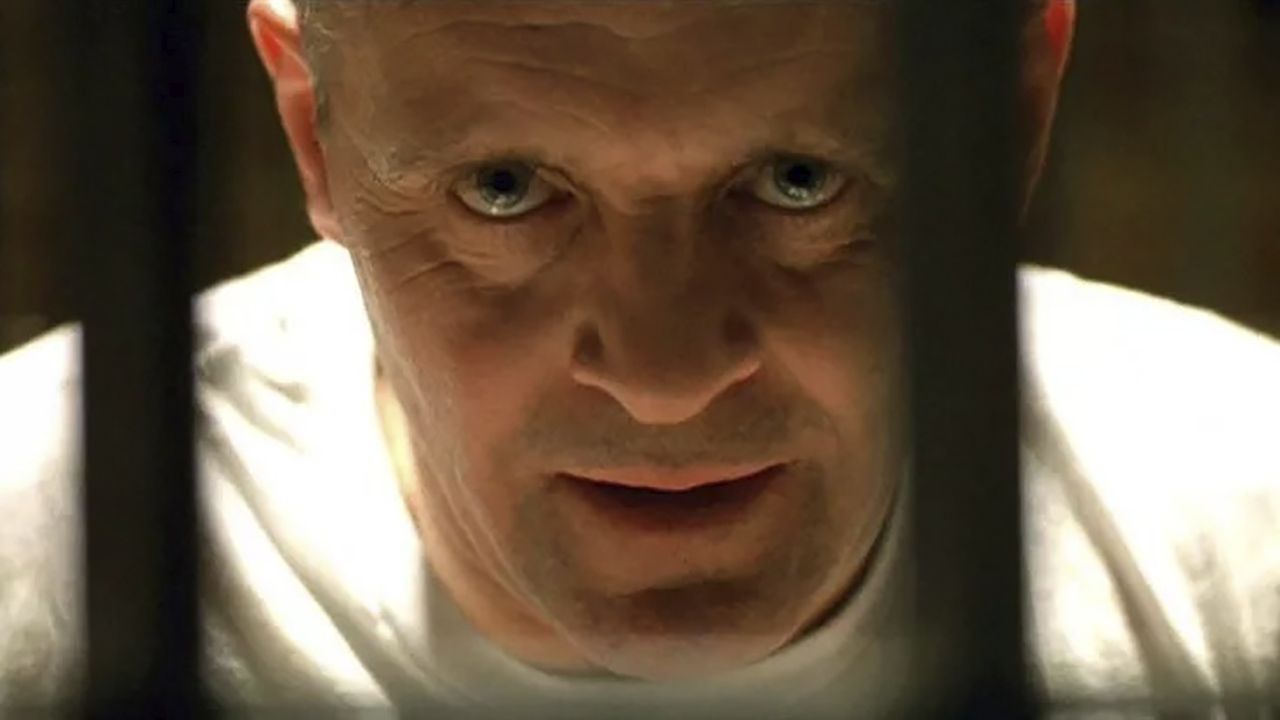 A close-up of Hannibal Lecter looking menacing in The Silence of the Lambs.