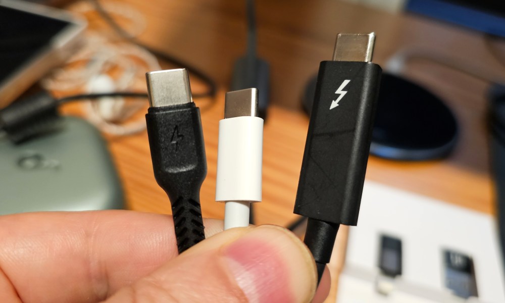 A selection of three USB-C cables being held in a hand.