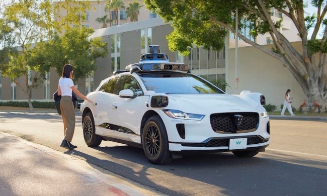 A Waymo robotaxi picking up a passenger.