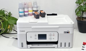 Canon's MegaTank Pixma G4280 with ink bottle on top sit on a printer stand.