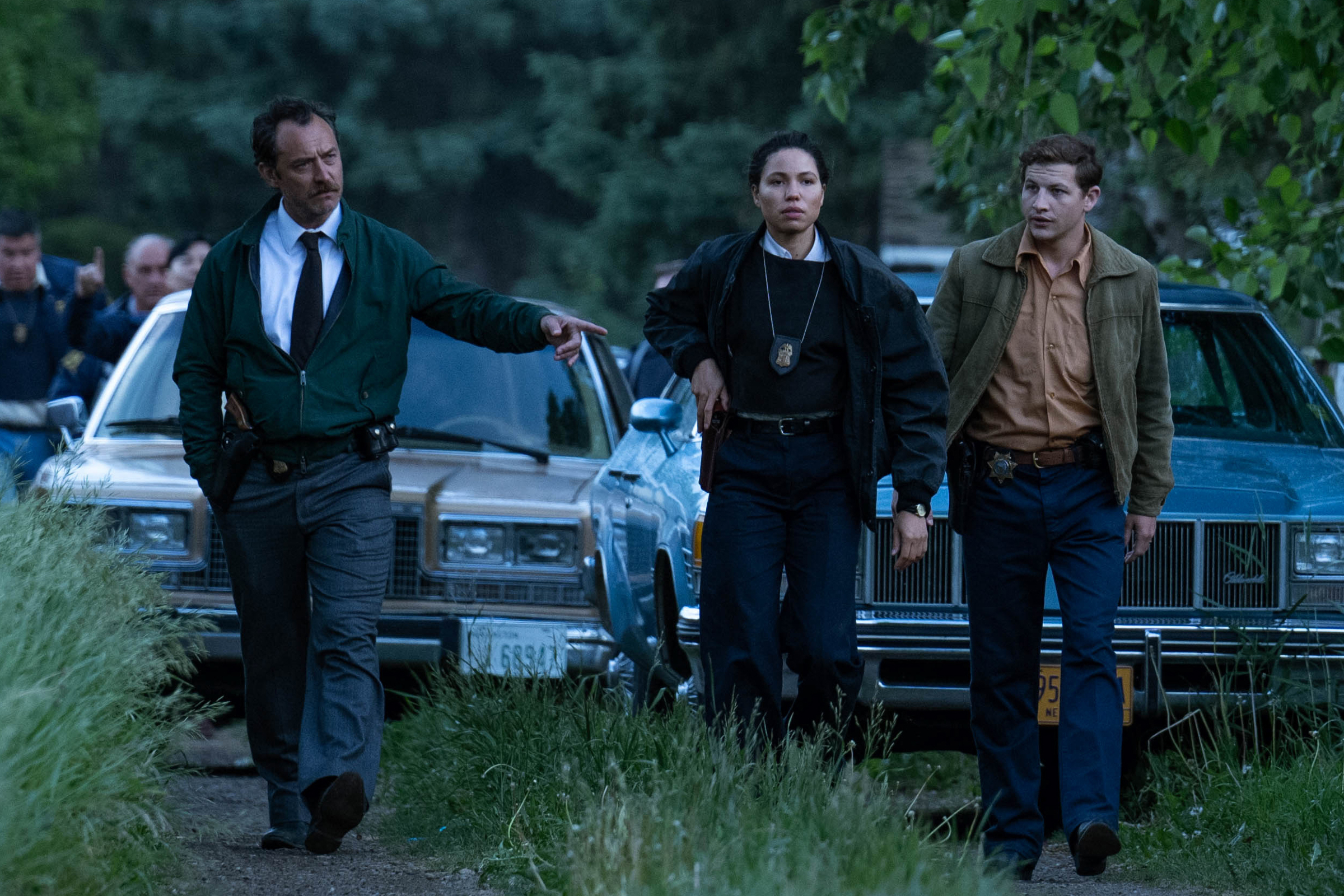 Jude Law walks with Jurnee Smollett and Tye Sheridan in The Order.