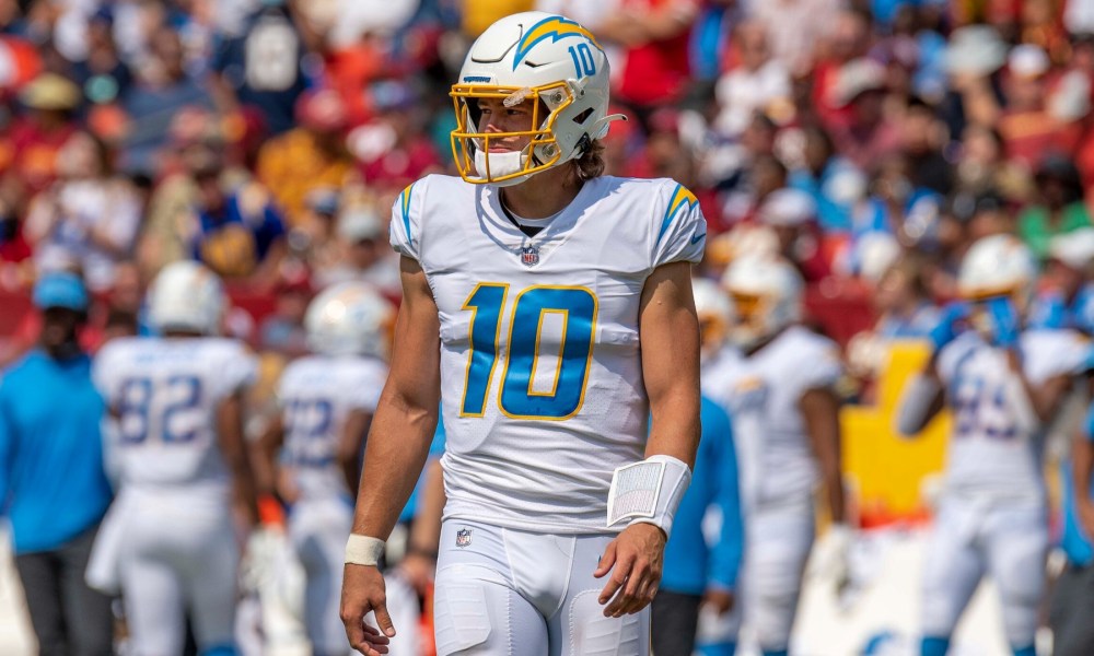 Justin Herbert walking on the football field for the Chargers.