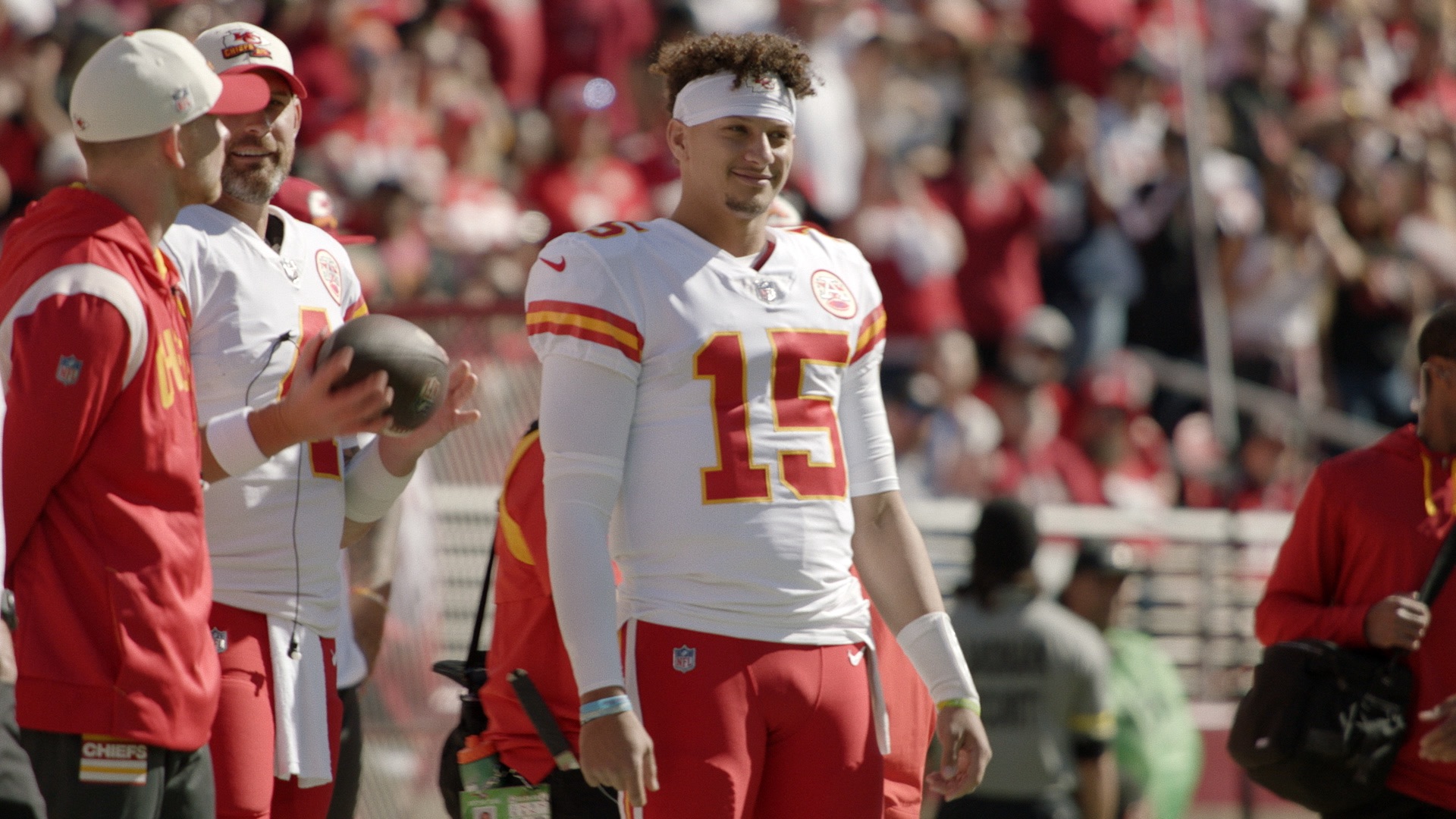 Patrick Mahomes stands on the sidelines for the Chiefs.