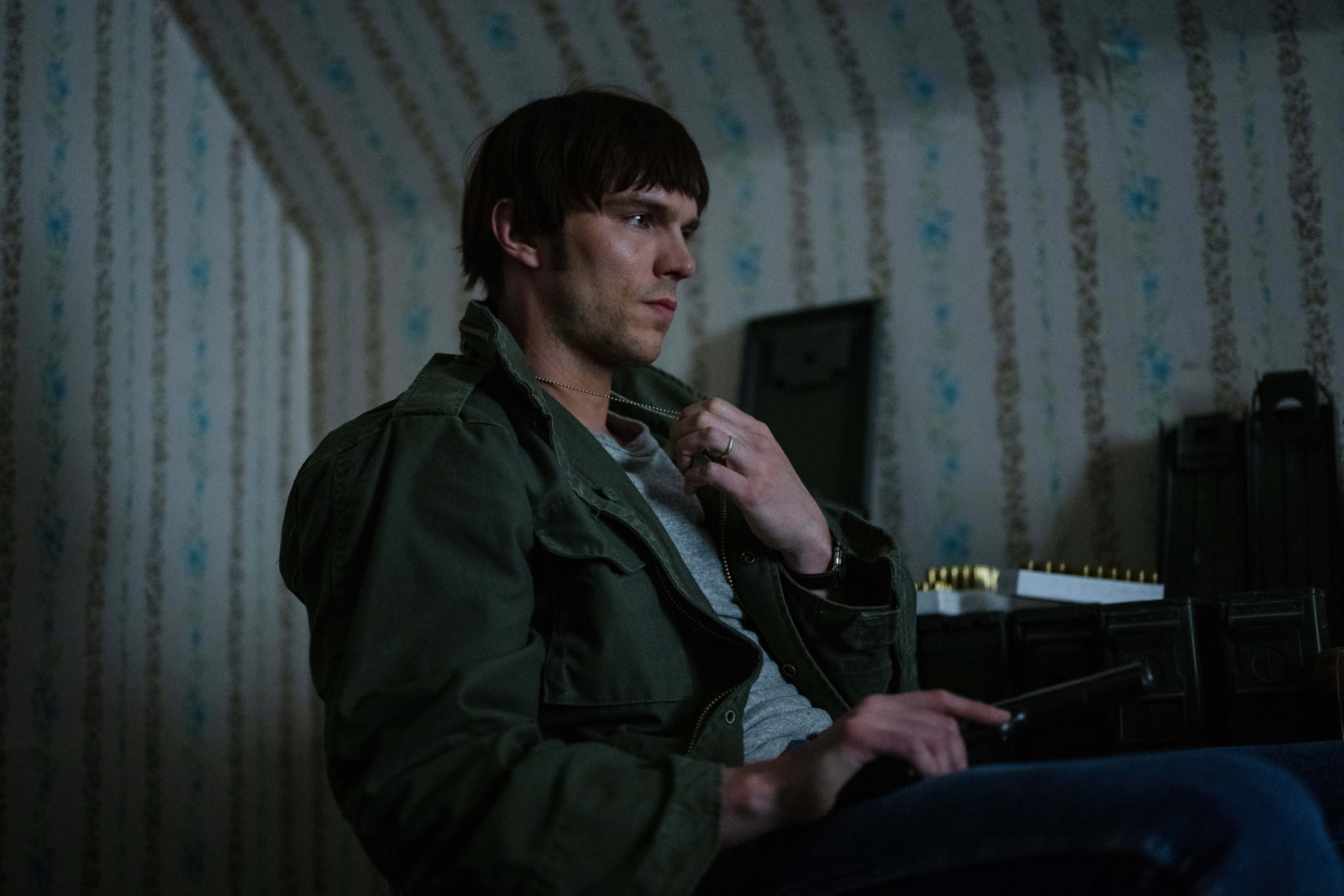 Nicholas Hoult wears a green military jacket in The Order.