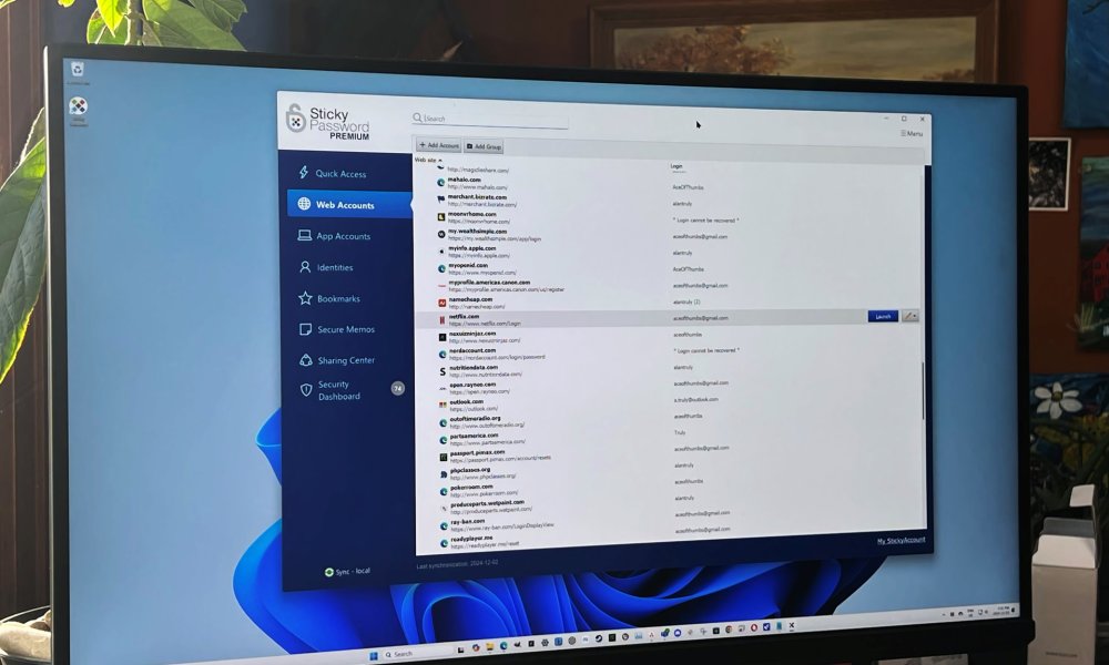 Sticky Password is open on a PC monitor.