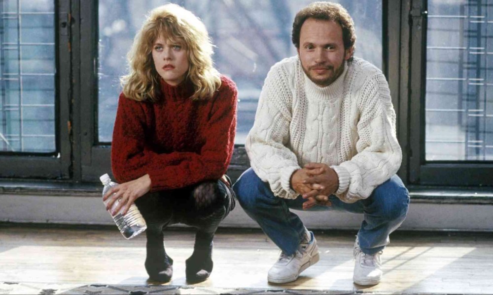 A man and woman crouch beside one another in When Harry Met Sally.