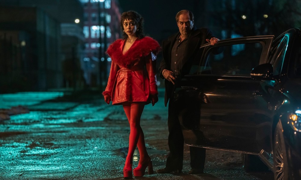 A woman and a man stand outside a car in The Penguin.