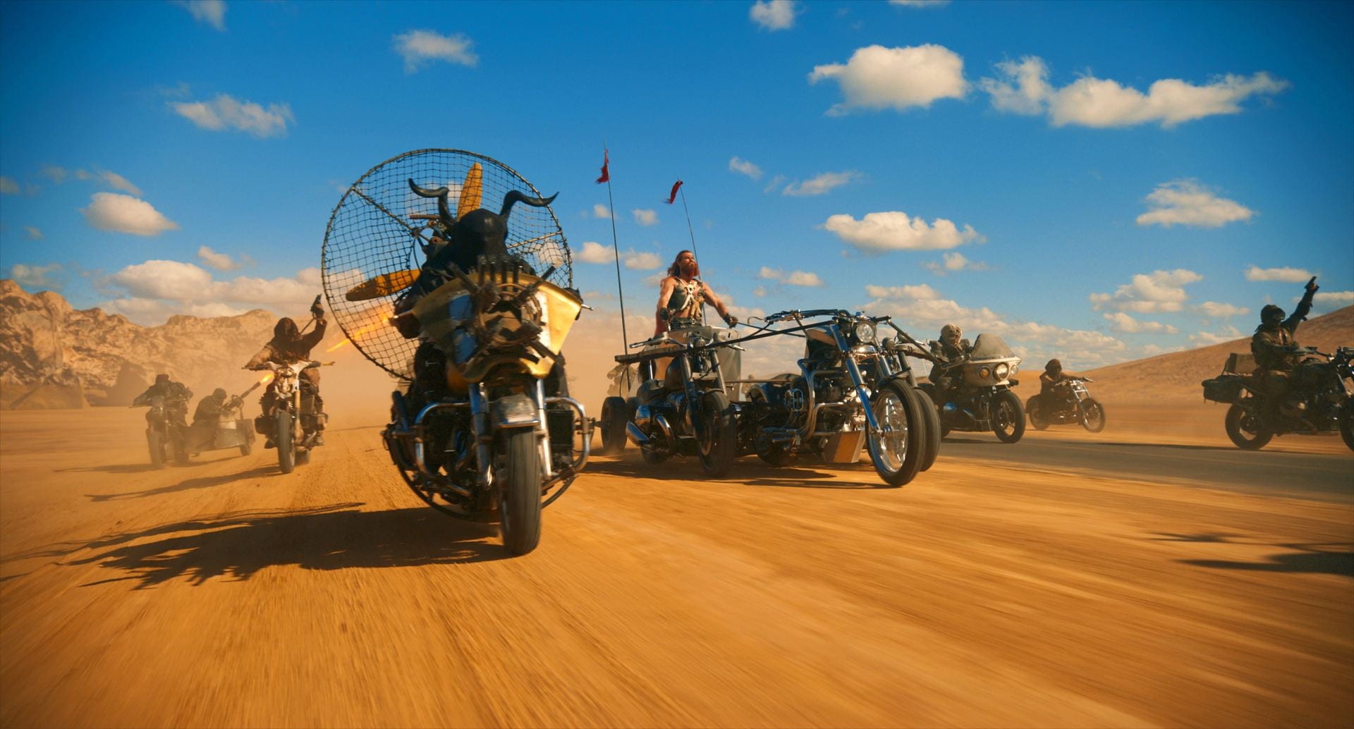 A motorcycle gang rides in the desert in Furiosa.