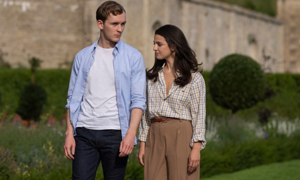 Robert and Yasmin hold hands and walk in Indsutry.