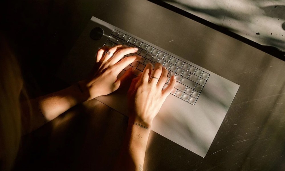 Hands typing on The Icebreaker keyboard.