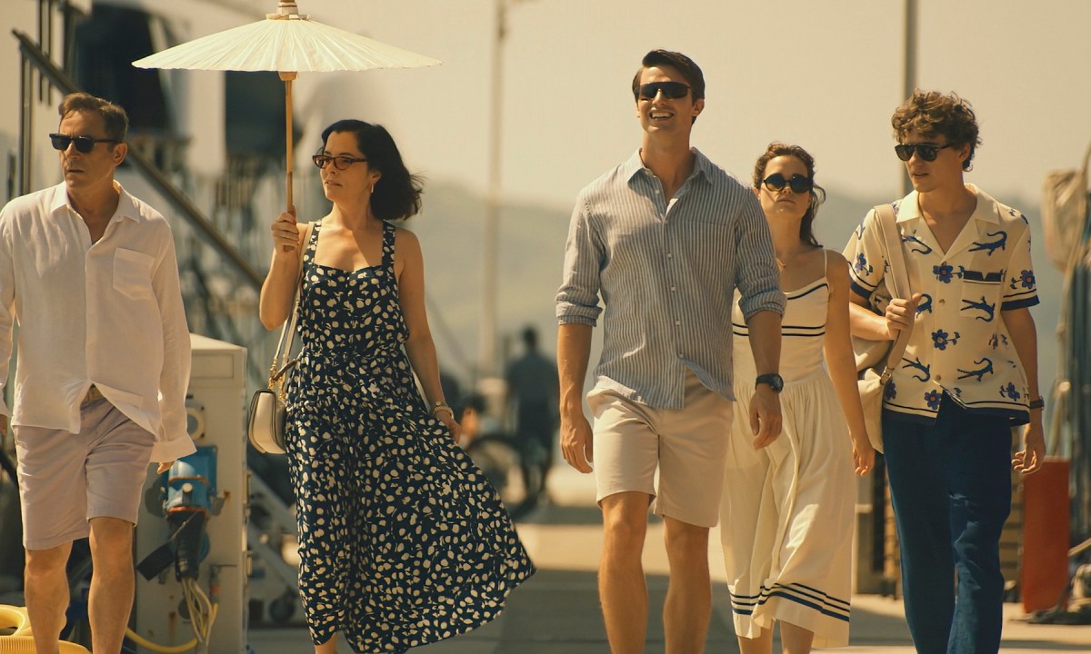 A group of people walking down the street in The White Lotus.