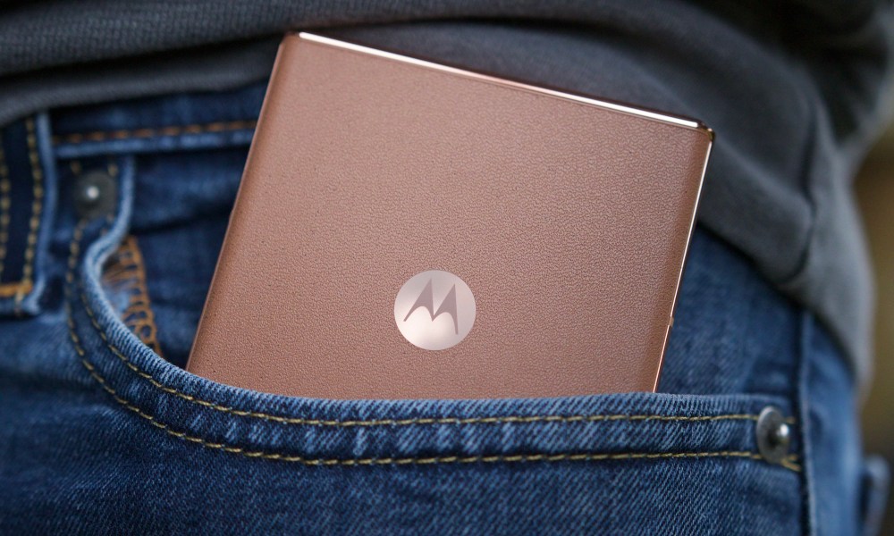 The Mocha Mousse Motorola Razr Plus in someone's pocket.