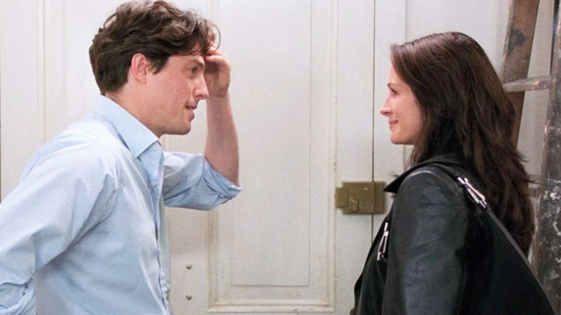 Hugh Grant et Julia Roberts se regardent devant une porte.