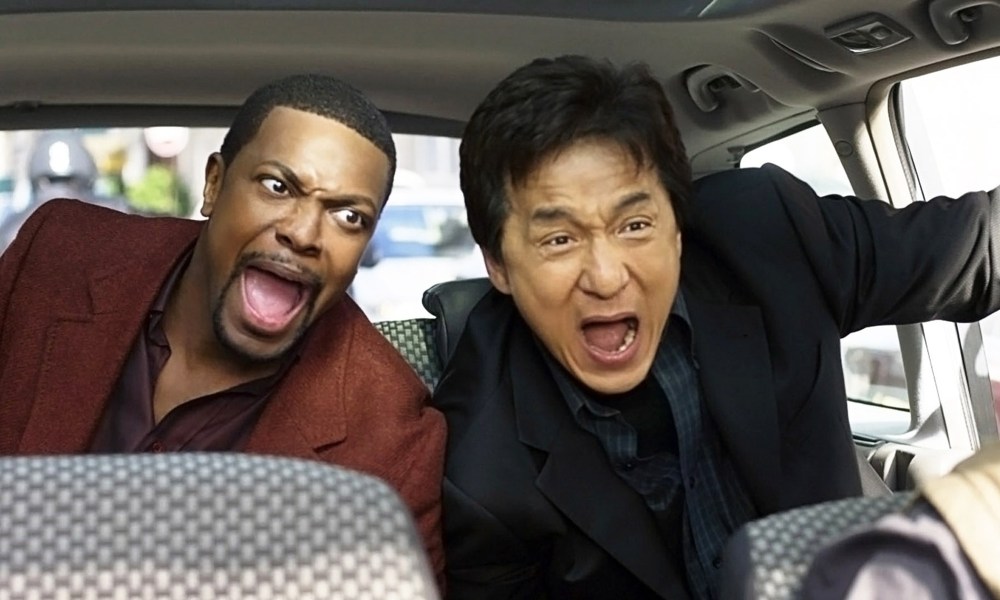 Chris Tucker and Jackie Chan in the backseat of a car both screaming in Rush Hour.