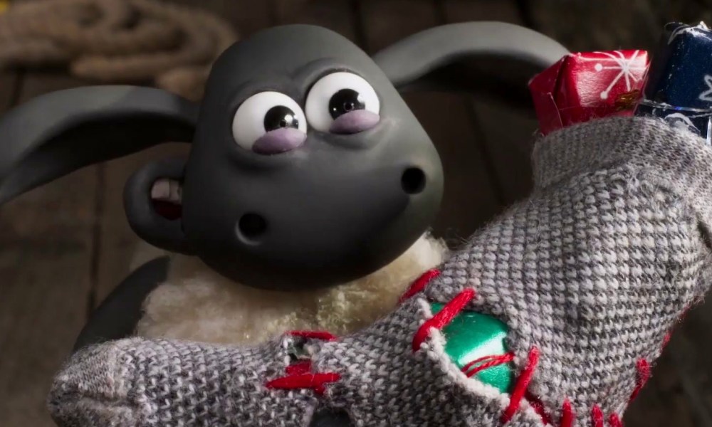 Shaun the Sheep rips open a Christmas stocking.