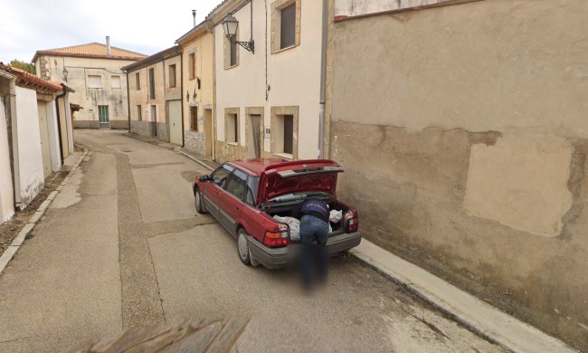 The Google Street View image showing someone loading a large bundle into the trunk of a car.